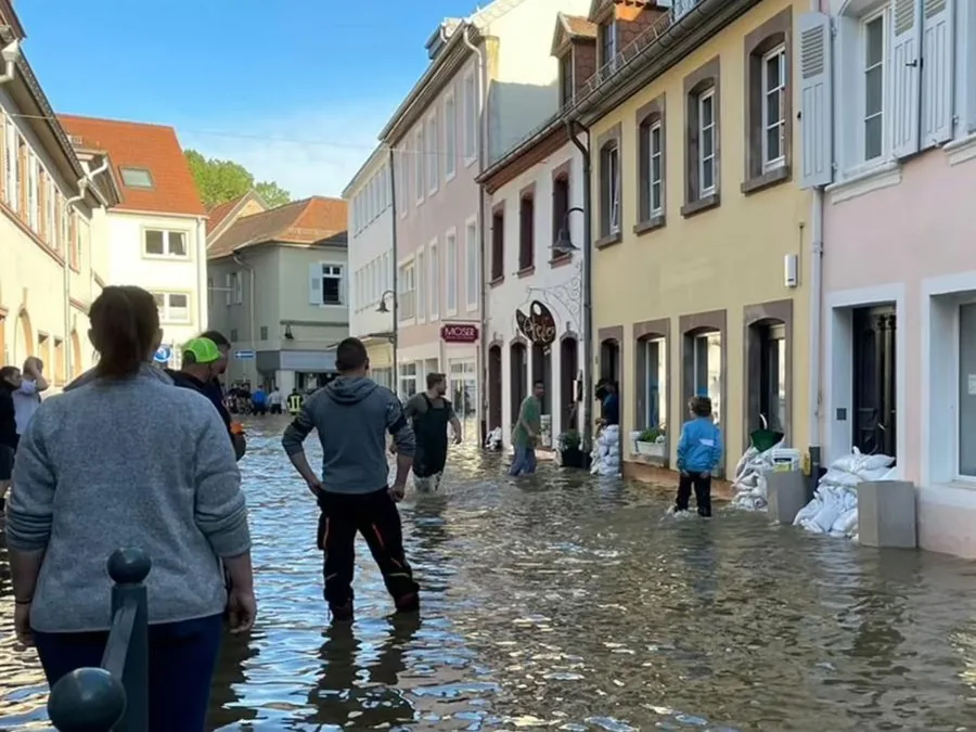 Überflutete Altstadtstraße in Blieskastel, Anwohner waten durchs Wasser